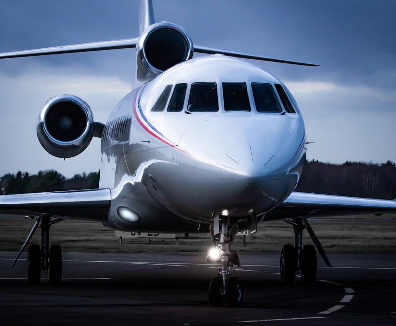 a private jet on the runway in twilight