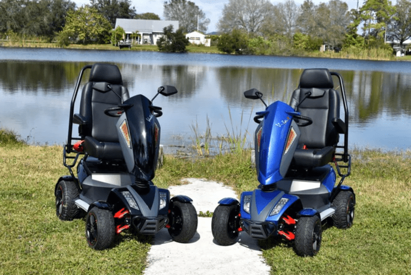 two mobility scooters by a lake